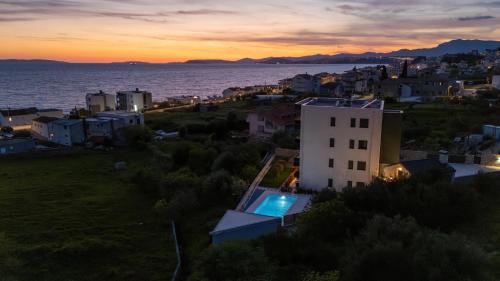 a view of a city and the ocean at sunset at Villa Donatella in Podstrana