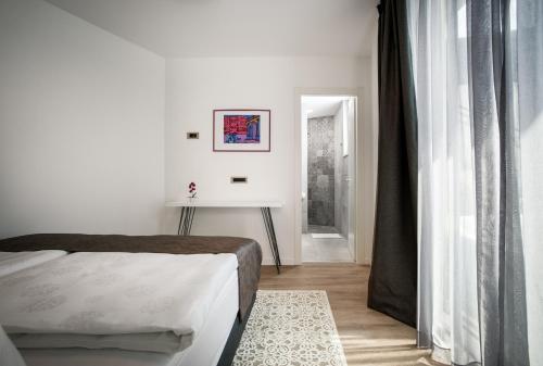 a bedroom with a bed and a hallway with a window at Hotel - Teranea City Hvar in Hvar