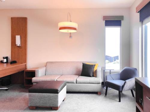 a living room with a couch and a chair at Hyatt Place Houston- Northwest/Cy-Fair in Houston