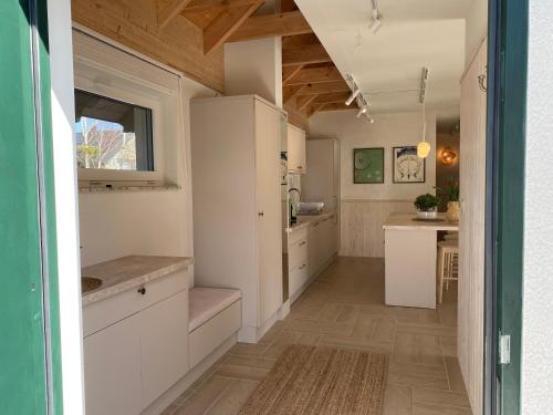 a kitchen with white cabinets and a counter top at Choriatiki in Dębki