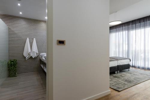a room with a bedroom with a bed and a mirror at Hotel - Teranea City Hvar in Hvar
