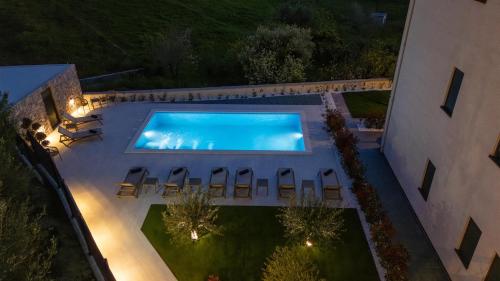 an overhead view of a swimming pool at night at Villa Donatella in Podstrana