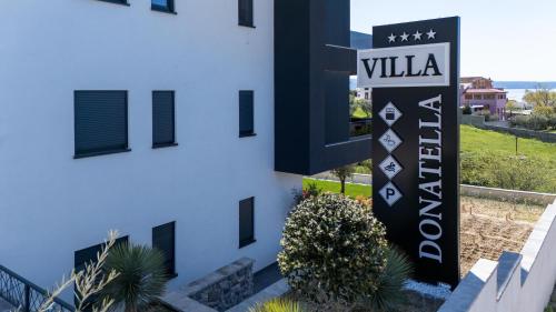 a building with a sign for a villa at Villa Donatella in Podstrana
