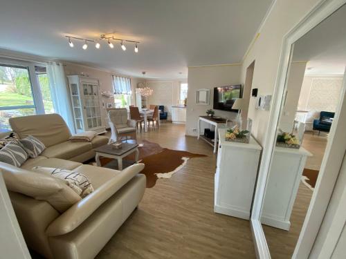 a living room with a couch and a dining room at Schöne Wohnung im Landhausstil nahe Olpe Biggesee in Olpe
