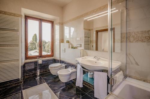 a bathroom with a sink and a toilet and a shower at Villa Lecchi Hotel Wellness in Colle Val D'Elsa