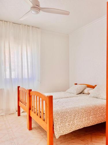 a bedroom with a bed and a ceiling fan at Casa Ramón in Vélez-Rubio