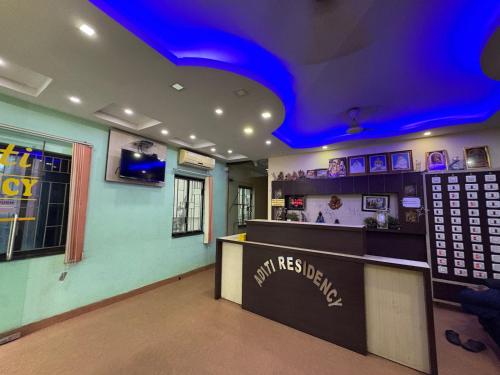 a bar in a restaurant with a blue ceiling at Aditi Residency New Digha Near Sea Beach in Digha