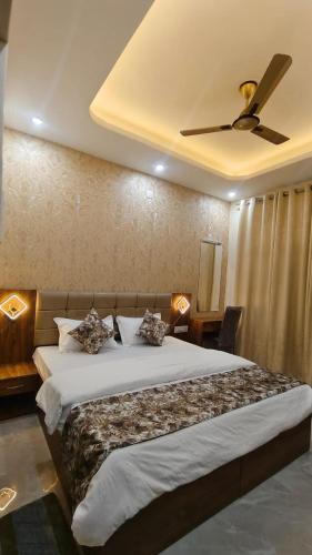 a bedroom with a large bed with a ceiling fan at Stay Purvi Ganga in Varanasi