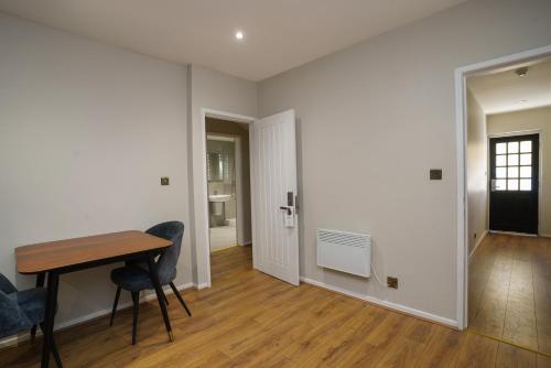 a room with a table and chairs and a hallway at Park hall Hotel & Spa Lancashire, a member of Radisson Individuals in Eccleston