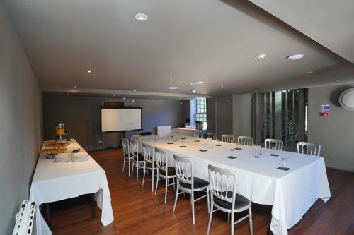 a conference room with a long table and chairs at Park hall Hotel & Spa Lancashire, a member of Radisson Individuals in Eccleston