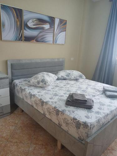 a bed in a bedroom with a blanket on it at Roxy's house in Vlorë