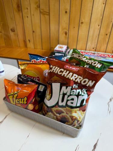 a box of chips and other snacks on a counter at FYLL Homes Francheska Suite Calvario St Cavinti Town Proper in Cavinti