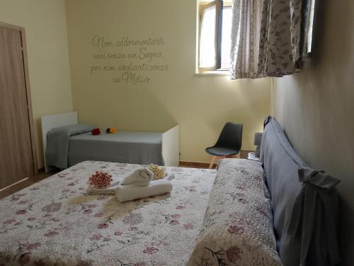 a bedroom with a bed with a stuffed animal on it at Casa Nonna Leondina in Spoltore