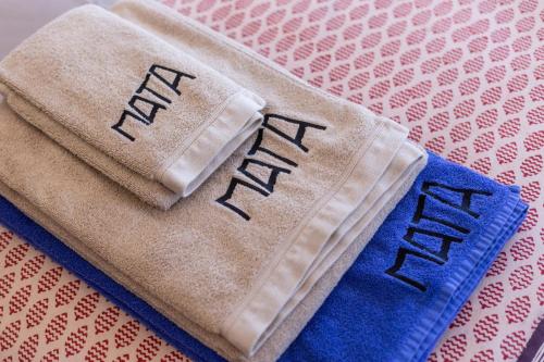 a towel with the word new written on it at Elegant villa, beautiful ocean view, natural paradise! in Tavira