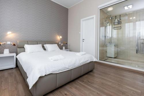 a bedroom with a large bed and a shower at Top City Center Apartment! in Budapest