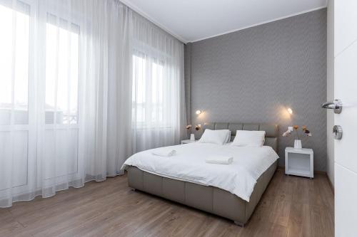 a bedroom with a large bed with white sheets at Top City Center Apartment! in Budapest
