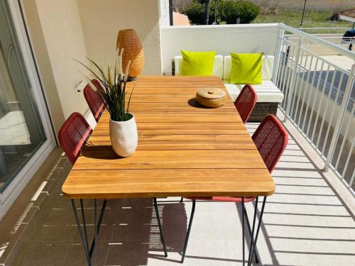 a wooden table and chairs on a balcony at Vasto Marina Dreamhouse in Vasto