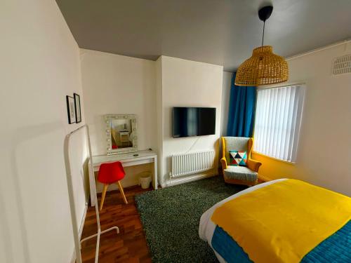 a bedroom with a bed and a chair and a mirror at Titanic Shadow - 5 mins from Belfast City Centre in Belfast