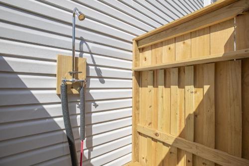 a hose is hooked up to a wooden wall at Cardinal Seas home in Morehead City