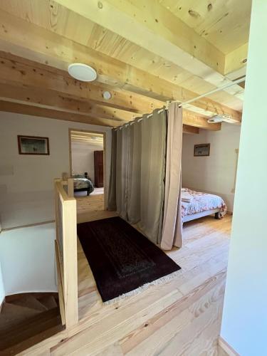 a room with a bed in a room with wooden ceilings at Chez Maria in Corbel