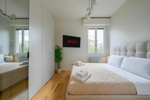 a white bedroom with a large bed in a room at BellaVita Boutique Florence in Florence