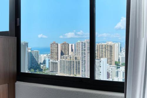 a window with a view of a city skyline at Holiday Inn Express Waikiki by IHG in Honolulu