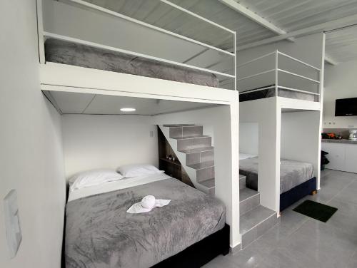 a bedroom with a bunk bed with a hat on it at Cabaña Retiro del Bosque Popayán in Popayan