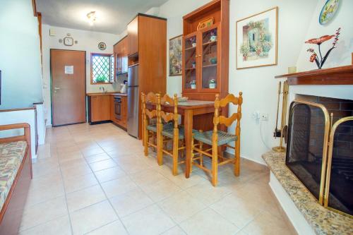 a kitchen with a table and a fireplace at Casa Costa near the beach in Kassandria
