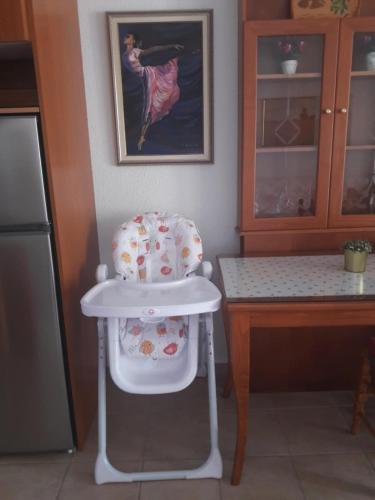 a high chair sitting next to a table in a kitchen at Casa Costa near the beach in Kassandria