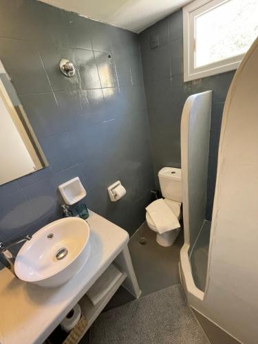 a bathroom with a sink and a toilet at Spanos Studios - Panteli in Panteli