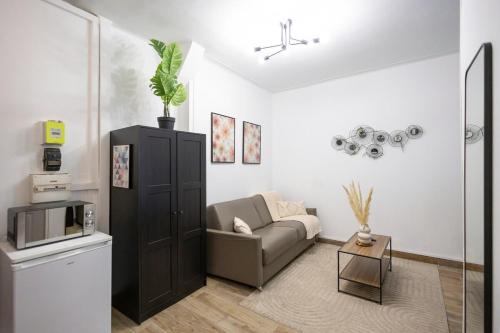 - un salon avec un canapé et un four micro-ondes dans l'établissement Studio à 2 min métro 13 - accès Paris Champs-Élysées, à Asnières-sur-Seine