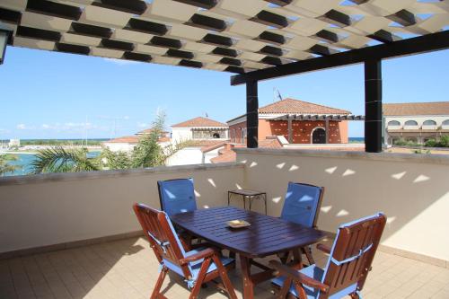 a table and chairs on a balcony with a view at Marinagri Resort in Policoro