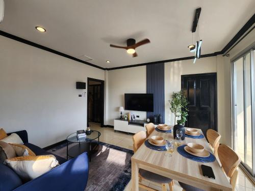 a living room with a table and a couch at Wink City 2 Patong Center close to the Beach in Patong Beach
