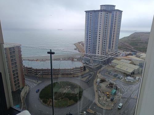 a view from a window of a city and the ocean at E1 Studios, Sea & Beach Views, High Floor in Gibraltar