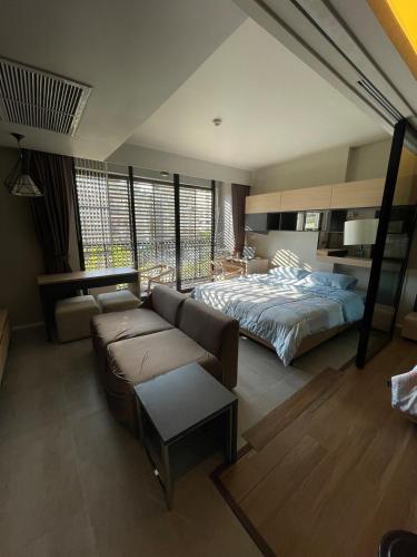 a living room with a bed and a couch at 4Pax MRT BTS Asoke, Terminal21 in Bangkok
