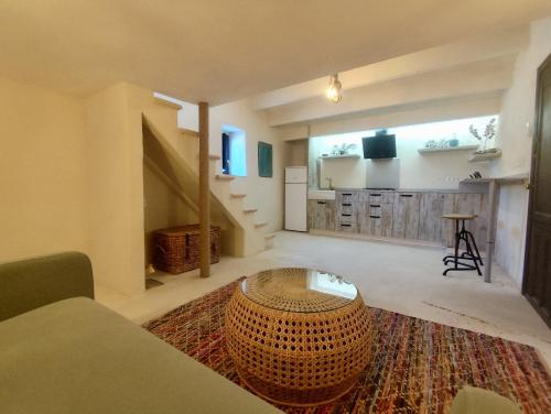 a large living room with a large rug and a table at La Casita de La Abubilla in L'Aldea