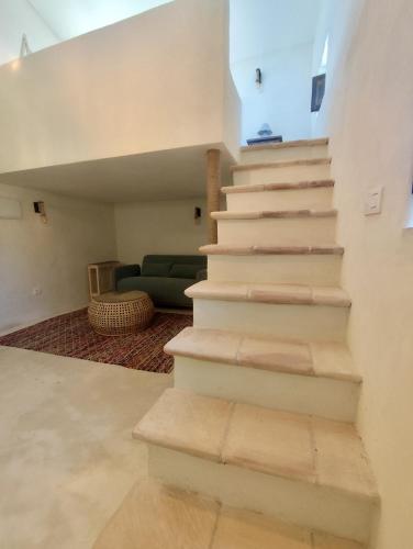 a staircase in a house with a living room at La Casita de La Abubilla in L'Aldea
