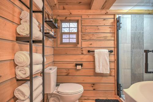 a bathroom with wooden walls and a toilet and a sink at Luxury in the Smokey Mountains Pet Friendly with Hot Tub in Elizabethton