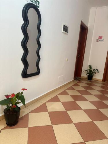 a hallway with a black wavy mirror on the wall at Vila Reni Risi in Ksamil