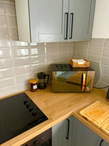 a kitchen with a counter top with a toaster oven at Bloom19 Traditional Belfast Entire House 10 mins from City Centre in Belfast