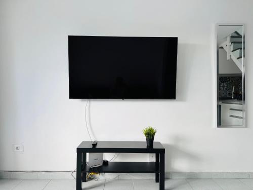 a flat screen tv hanging on a white wall at Bungalow Simone in Maspalomas