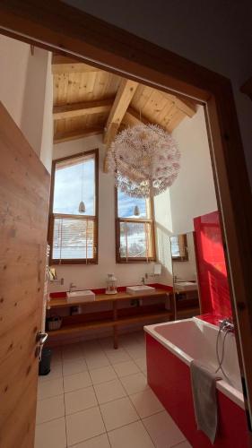 a large bathroom with a tub and a sink at Chalet ChampBenoit in Valmorel