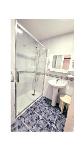 a bathroom with a shower and a sink at Pension Villa ** in Comillas