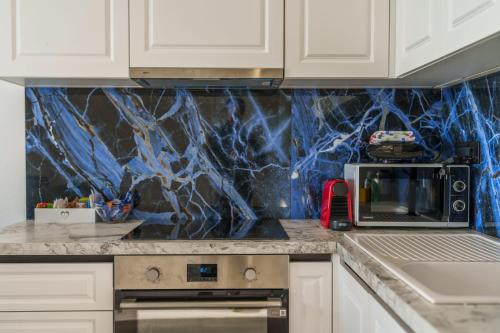 a kitchen with a counter top with a microwave at Stella di mare - appartamenti vista incantevole su Moneglia in Moneglia