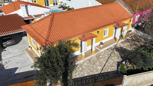 an overhead view of a yellow house with an orange roof at Casal da FontAgrão in Rio Maior