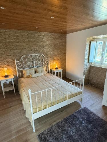 a bedroom with a white bed and two night stands at Casal da FontAgrão in Rio Maior