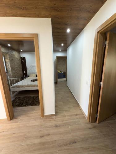 a hallway with a bedroom and a bed in a room at Casal da FontAgrão in Rio Maior