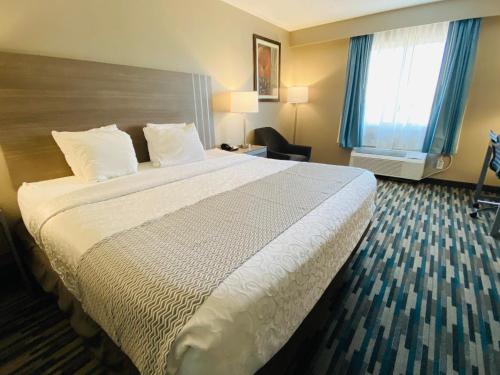 a hotel room with a large bed and a window at Best Western Edinburgh/Columbus in Edinburgh