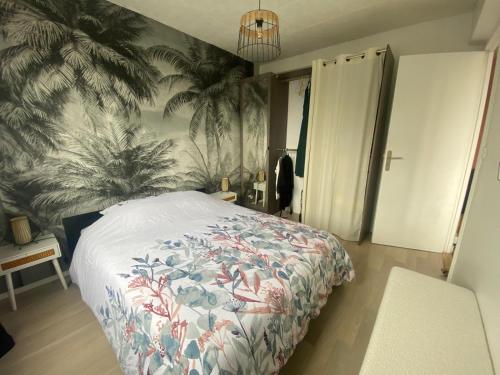 une chambre avec un lit avec un papier peint tropical dans l'établissement Entre terre & Mer, à Saint-Brieuc