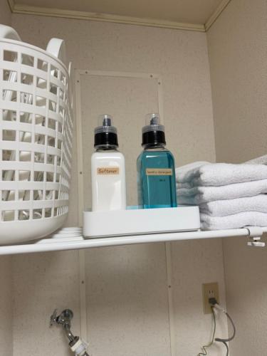 two bottles ofodorizers sit on a shelf in a bathroom at inn 2nd 102 in Kurashiki